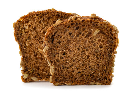 Two slices of cereal bread with sunflower seeds
 isolated on white backgroundの写真素材