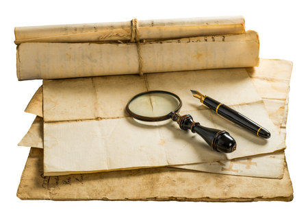 Pen and magnifying glass with old sheets isolated on withe backgroundの写真素材