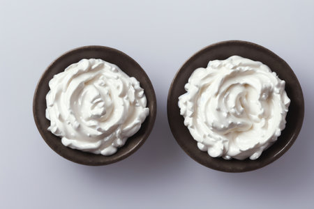bowls of sour cream on a white background, top view.の素材