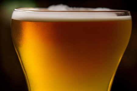 A Glass Of Beer Sitting On Top Of A Table. Generative AIの素材