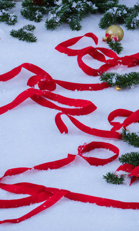 Christmas Ribbons And Baubles Scattered In The Snow, In The Evening Light. Generative AIの素材