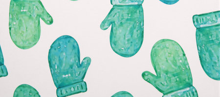 A hand-painted whimsical watercolor design of snowy green and blue mittens for holiday seasonal prints textiles wrapping paper or wallpaperの素材
