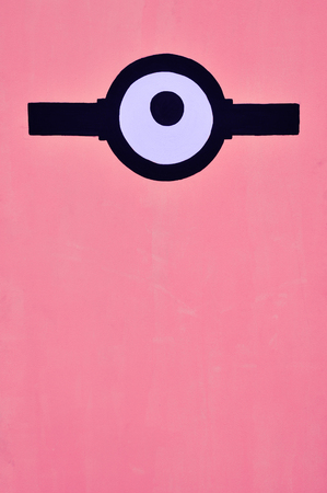 Coral color background with one eyeの写真素材