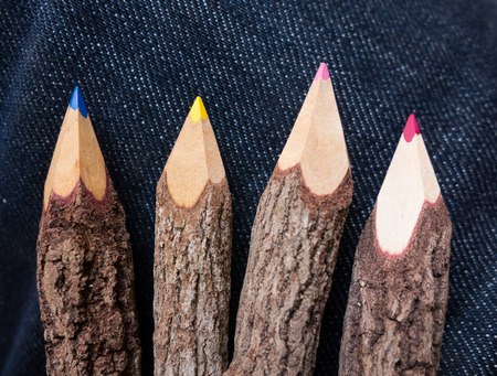 wooden colored pencils with jean in backgroundの写真素材