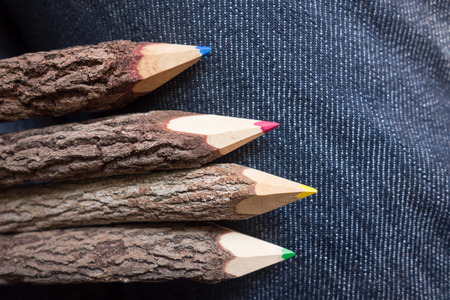 wooden colored pencils with jean in backgroundの写真素材