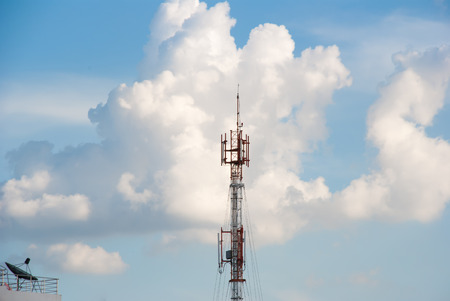 cell phone post and satellite with blue sky in backgroundの写真素材