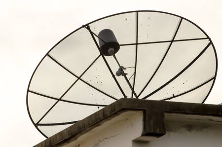 The dirty satellite dish and the white background isolatedの写真素材