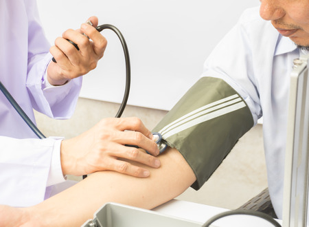 The doctor checking blood pressure of patient