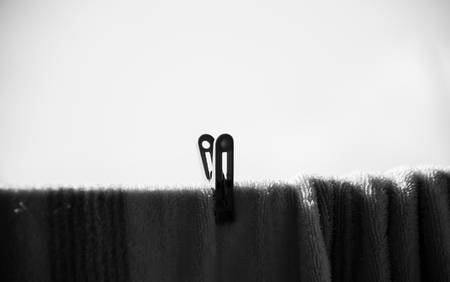 Black and white of one clothespin attach to cloth , alone conceptの写真素材