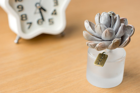 The love tag on perfume bottle and clock in backgroundの写真素材