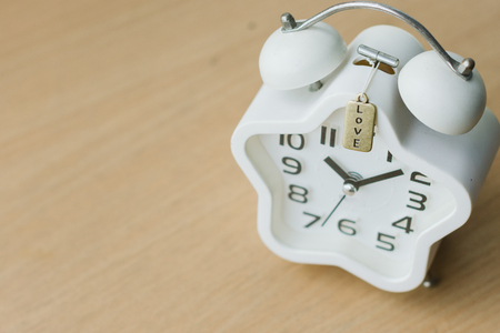 Top view close up of white clock on the wood tableの写真素材
