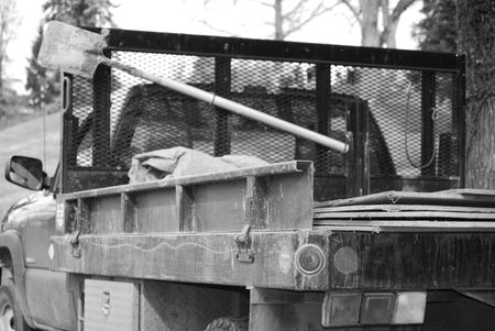 grave digger's shovel on the back of work truckの写真素材