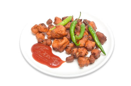 Cauliflower pakodas and ketchup, dressed with green chilies isolated on white backgroundの写真素材