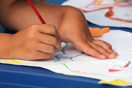 Seven year old female with water color paints.