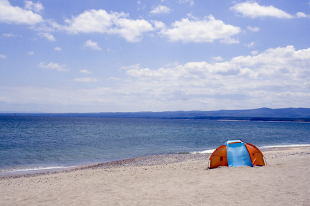 Black sea beach and tentの写真素材