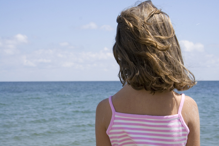 Little girl watching seaの写真素材