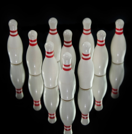Ten bowling pins isolated on black backgroundの写真素材