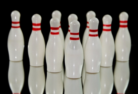 Ten bowling pins isolated on black backgroundの写真素材