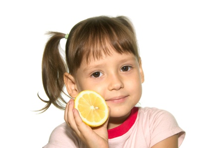 Cute Little girl with yellow fruit isolated on whiteの写真素材
