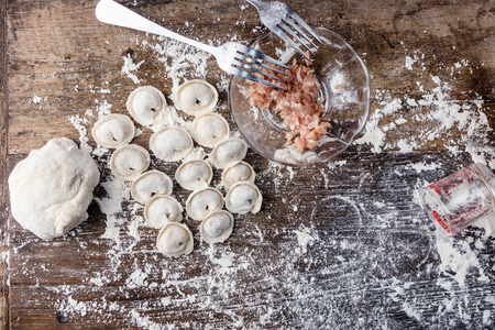 Top view flat lay raw russian dumplings with ingredients on table. Cooking background. Text spaceの写真素材