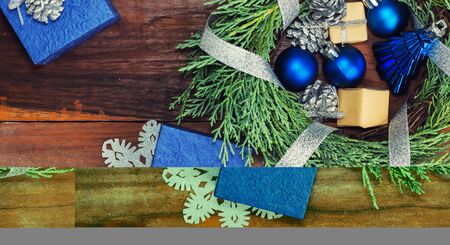 cypress wreath with christmas toys and gifts on wooden background. New year theme. Blue and silverの写真素材