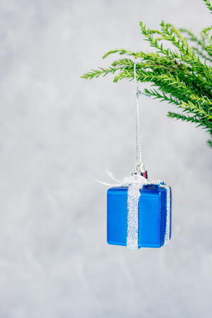 Christmas tree branches decorated with silver and blue toy gift. New year concept. Text spaceの写真素材