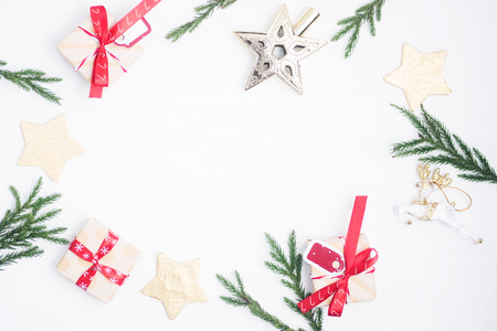 Flat lay, top view christmas composition. Christmas gift, pine cones, toys, fir branches on white background. New year conceptの写真素材
