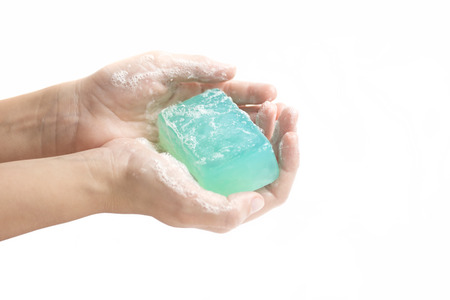Child washing hands with bright blue bar of soap on white background. Healthy lifestyle concept. Text spaceの写真素材