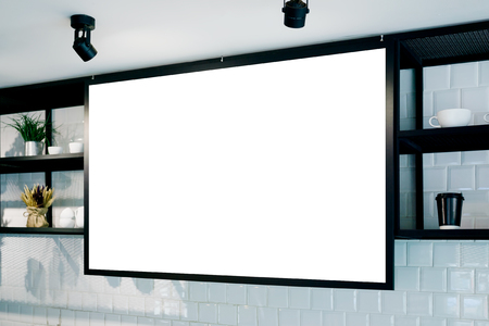 Empty wall banner at cafe mockup, side view. Coffe cups and plants on shelf in background. Scandinavian interior design. Text spaceの写真素材