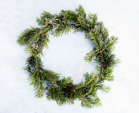 Top view flat lay green Christmas wreath on bright background. Traditional New year decoration concept. Space for letteringの写真素材