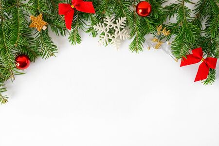 flat lay top view christmas tree branches frame with red gold toys and fir-cones on blue background. New year holiday concepr. Text spaceの写真素材