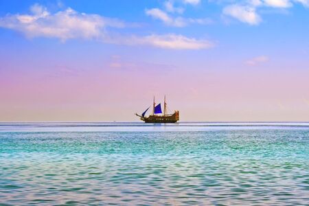 yacht with blue sail in open seaの写真素材