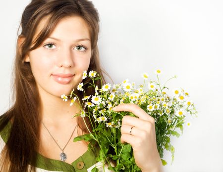 Beautiful young woman with camomilesの写真素材