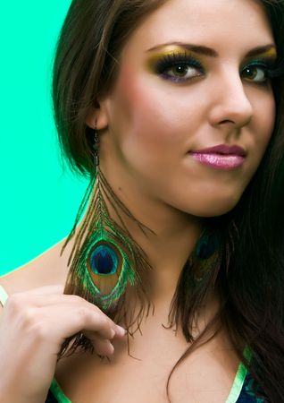 Portarit of beautiful young girl with peacock featherの写真素材