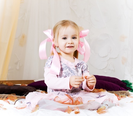 Very beautiful little girl with petalsの写真素材