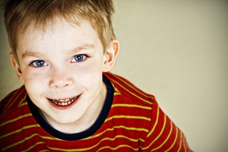Happy little boy with blue eyesの写真素材