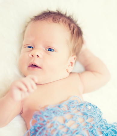 Cute newborn baby boy with blue eyes