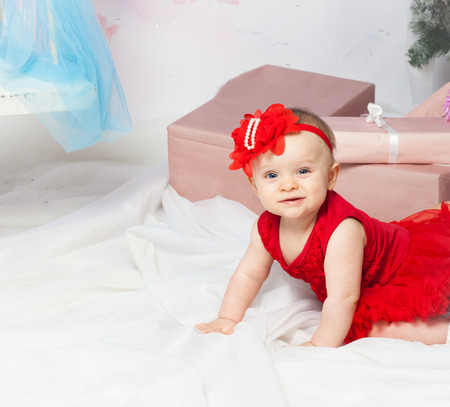 Little baby girl with christmas gift and copy spaceの写真素材