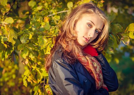 Beautiful young girl in autumn parkの写真素材