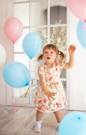 Birthday of little beautiful girl with balloonsの写真素材