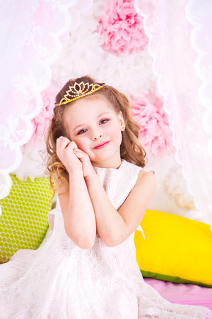 Little beautiful princess on the bedの写真素材