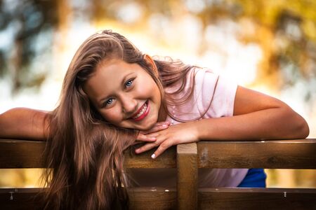 Portrait of beautiful happy teenage russian girl outdoorの写真素材