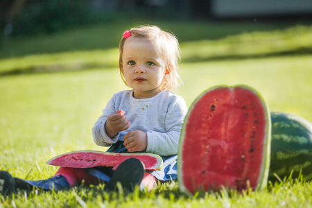 Little beautiful girl with watermelon outdoorの写真素材
