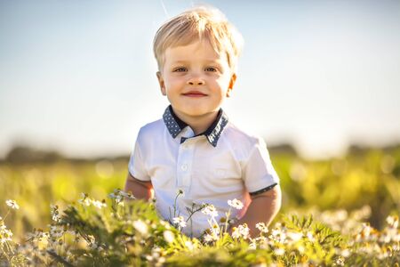 Happy summer boy outdoor in sunny dayの写真素材