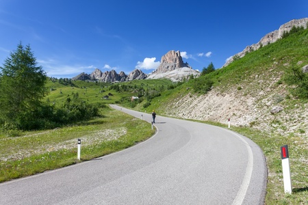 Man walks mountain road in the Dolomites の写真素材