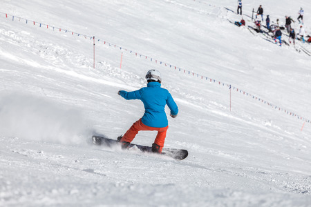 Woman on a snowboard in the mountainsの写真素材