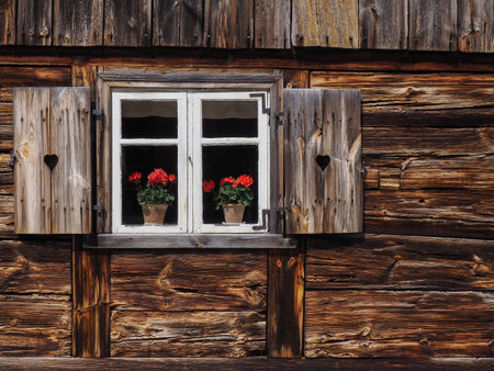 A window with shutters in old, wooden house