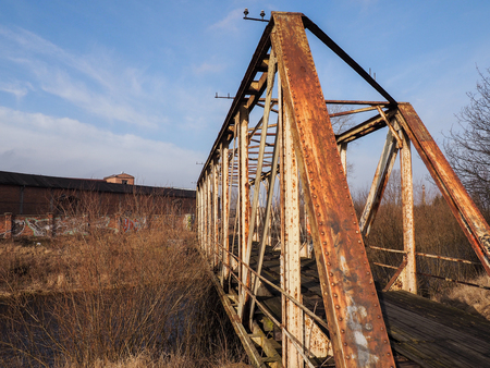 Old, forgotten bridge over the riverの写真素材