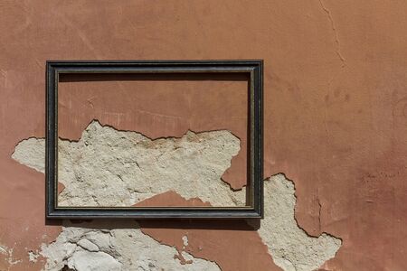 A decorated frame on an ugly wallの写真素材
