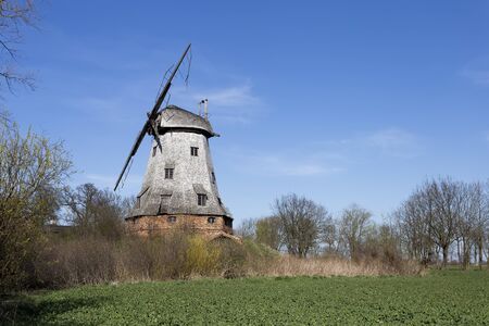 Old abandoned windmill with broken sailsの写真素材